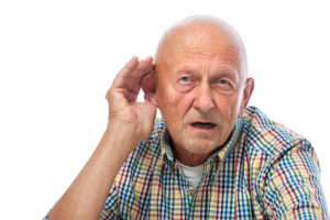 A man cupping his ear like he can't hear