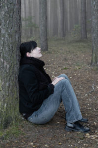 woman sitting in a foggy forest