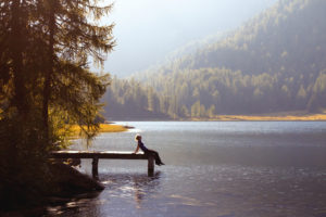 A woman alone on a boat dock