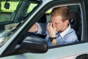 a frustrated driver sitting in his car