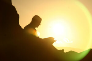 A man sitting in the sunset