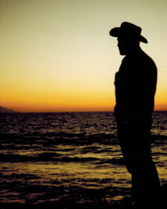 My Dad in his cowboy hat at sunset by the ocean