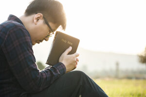 A Christian man holding the bible in his hands