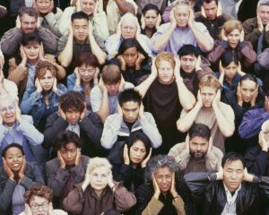 A group of people covering their ears