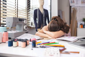 a frustrated young women sewing a dress